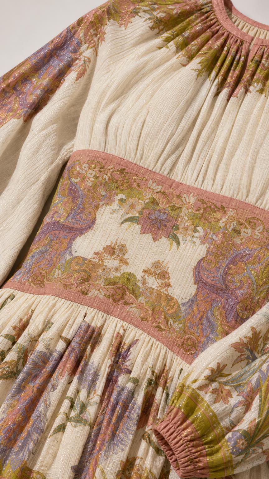 Close-up of textured fabric, gathered neckline, and printed waistband