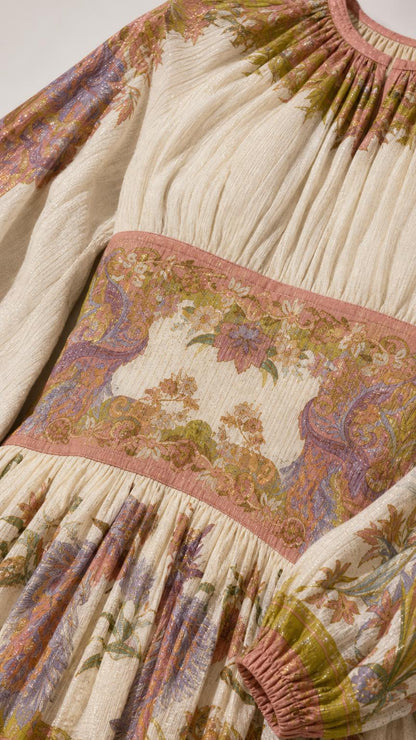 Close-up of textured fabric, gathered neckline, and printed waistband