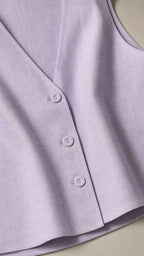 Close-up detail of lavender vest buttons and fabric texture