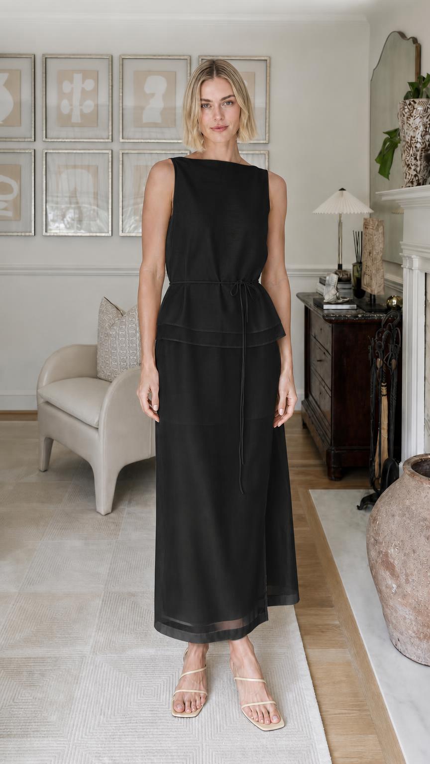 Woman wearing black sleeveless tiered maxi dress