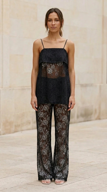 Model wearing black lace cami top and matching pants