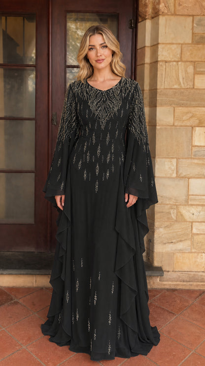 Model wearing black beaded long sleeve maxi dress