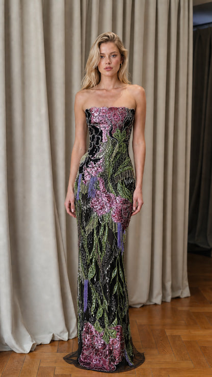 Model wearing black floral sequin strapless evening gown