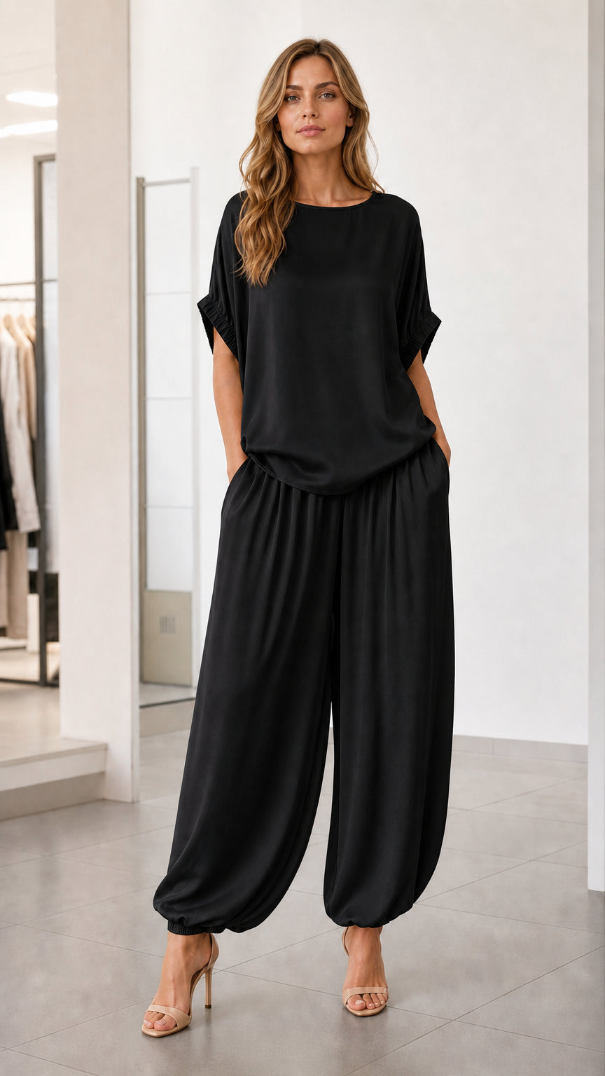Front view of model wearing black two-piece lounge set