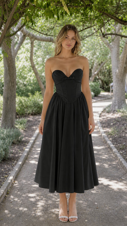 Front view of woman wearing black strapless corset midi dress
