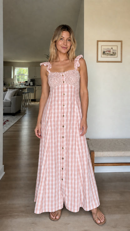 Woman wearing light pink gingham maxi dress