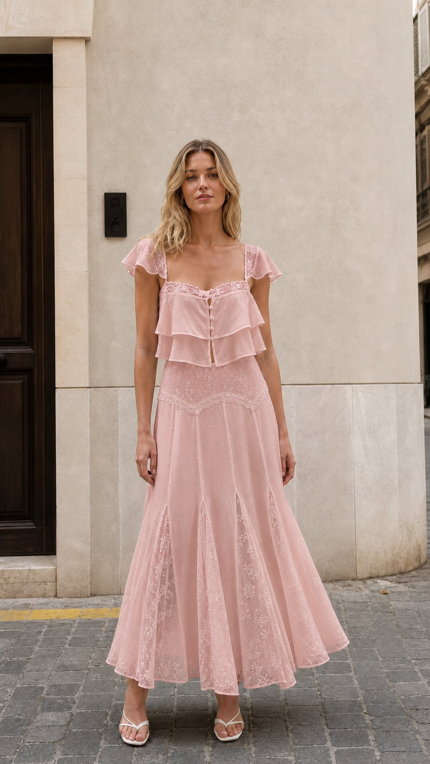 Front view of woman wearing pink ruffled two-piece maxi set