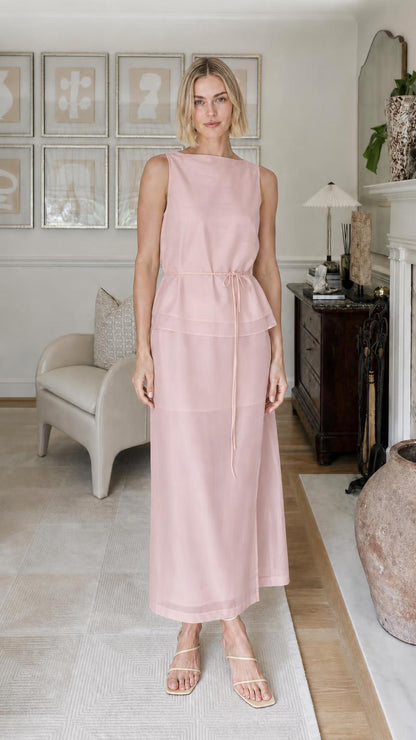 Woman wearing pink sleeveless tiered maxi dress