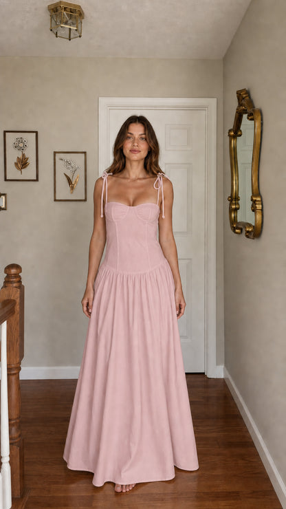 Front view of woman wearing pink tie-strap corset maxi dress
