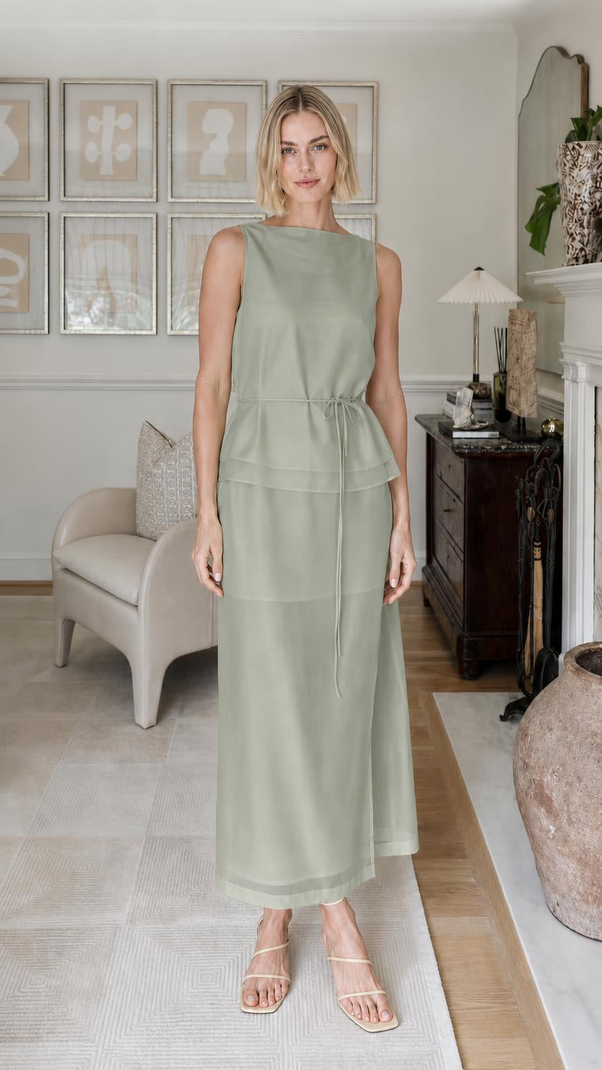 Woman wearing sage green sleeveless tiered maxi dress