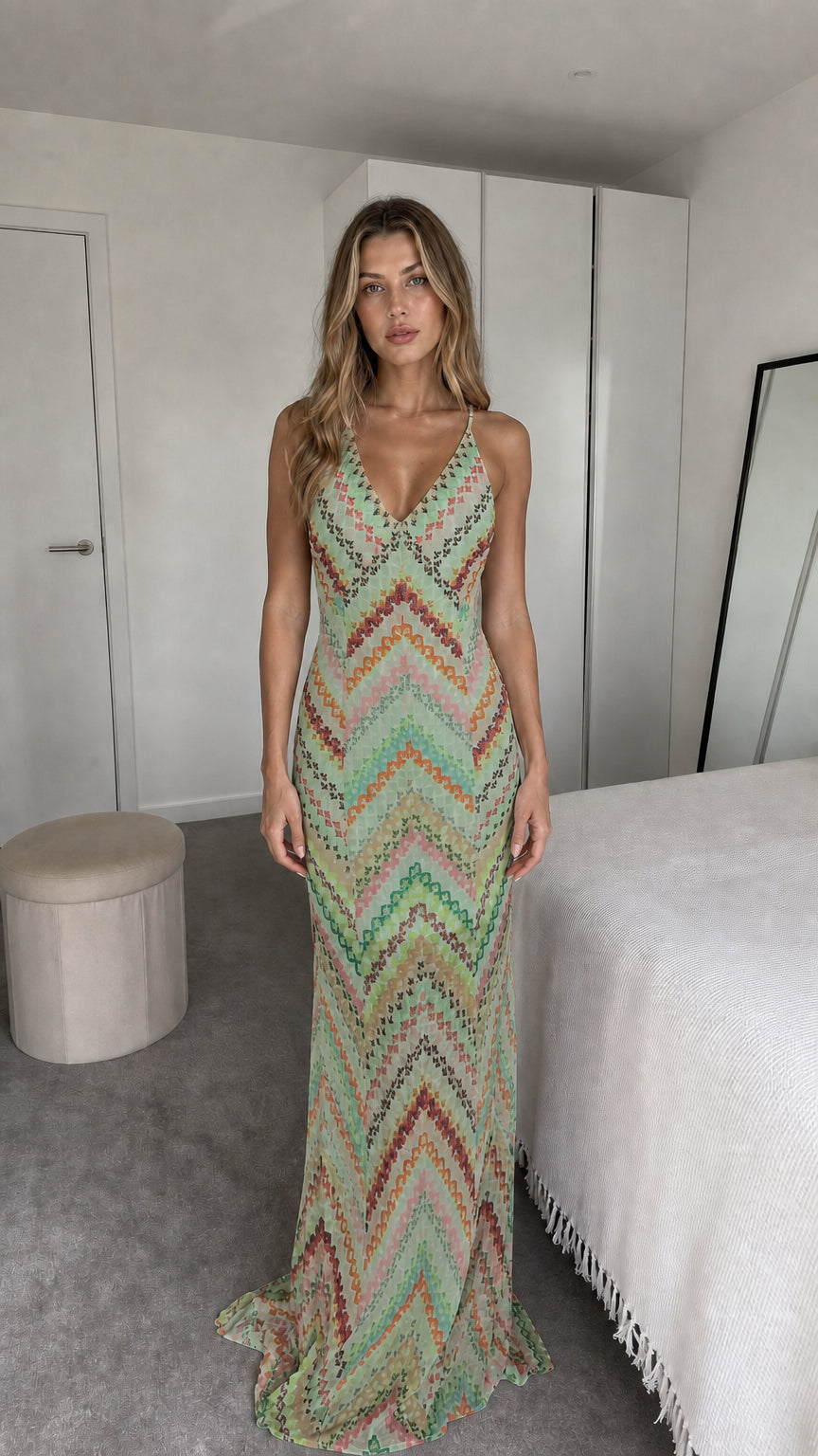 Front view of model wearing sage green chevron maxi dress