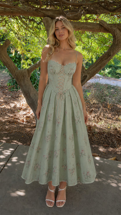 Woman wearing sage green floral corset midi dress