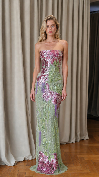 Model wearing sage green floral sequin strapless evening gown