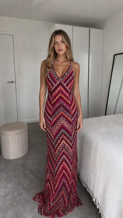 Front view of model wearing burgundy chevron maxi dress