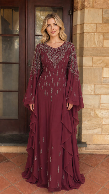 Model wearing burgundy beaded long sleeve maxi dress
