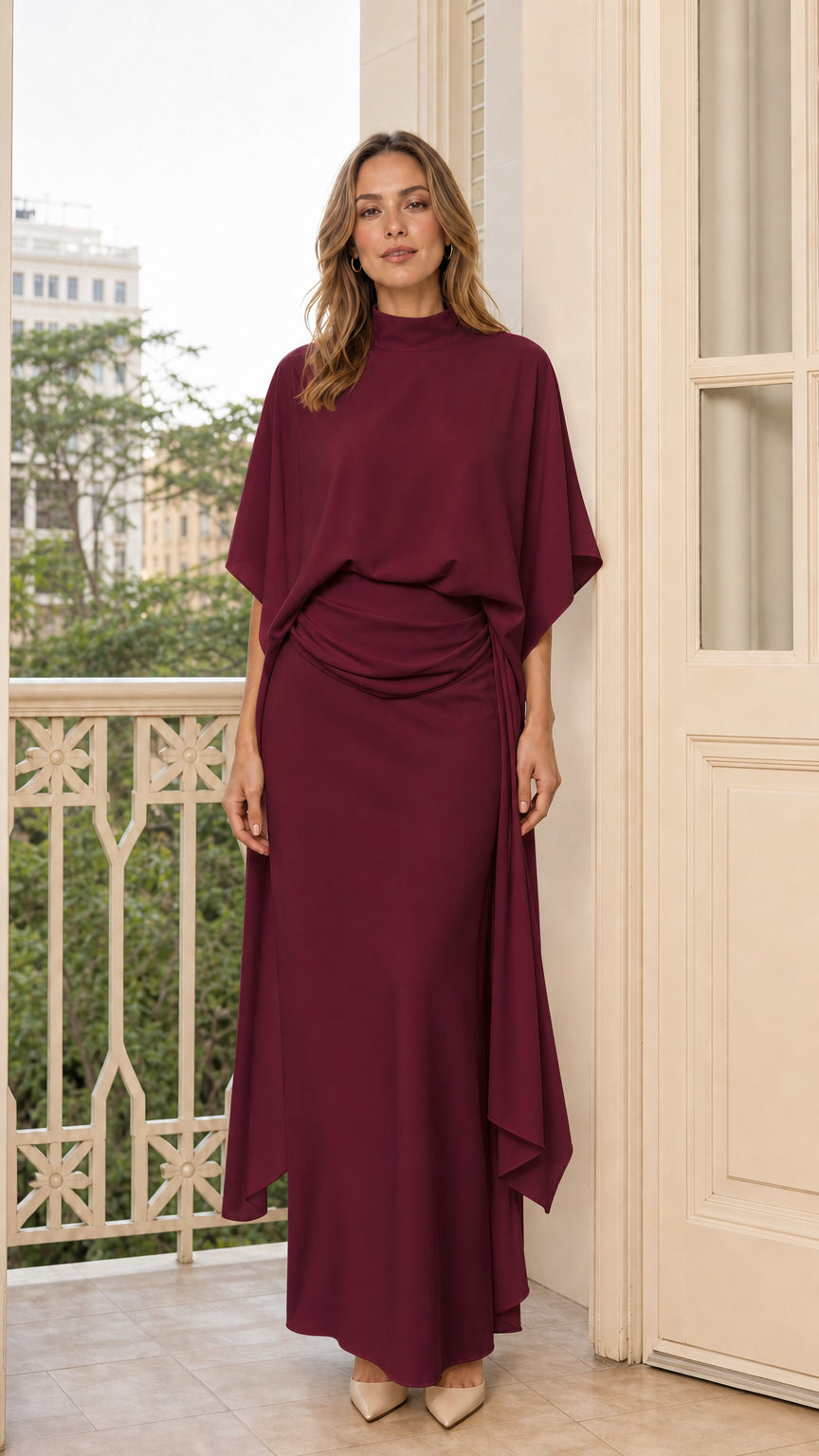 Front view of model in burgundy draped mock neck maxi dress