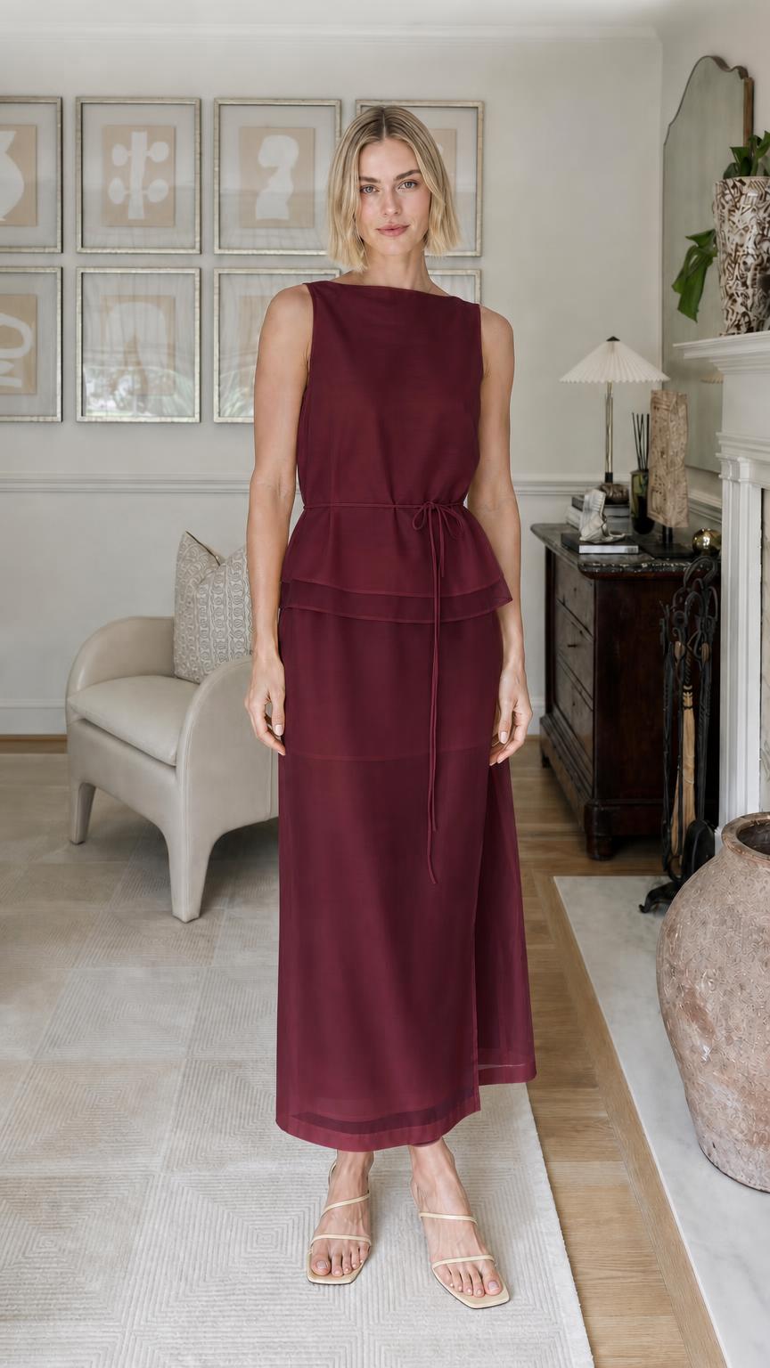 Woman wearing burgundy sleeveless tiered maxi dress
