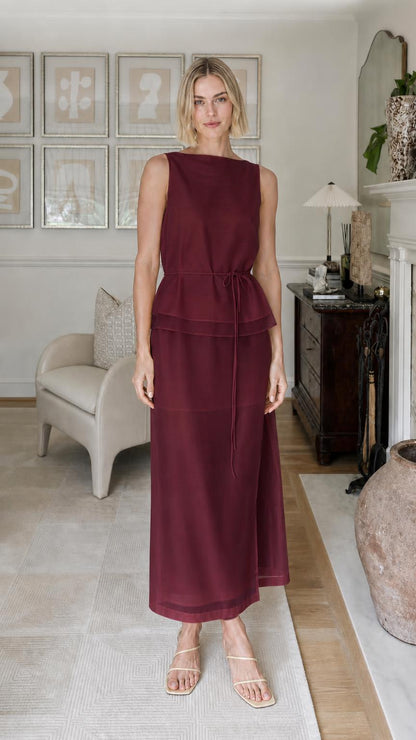 Woman wearing burgundy sleeveless tiered maxi dress