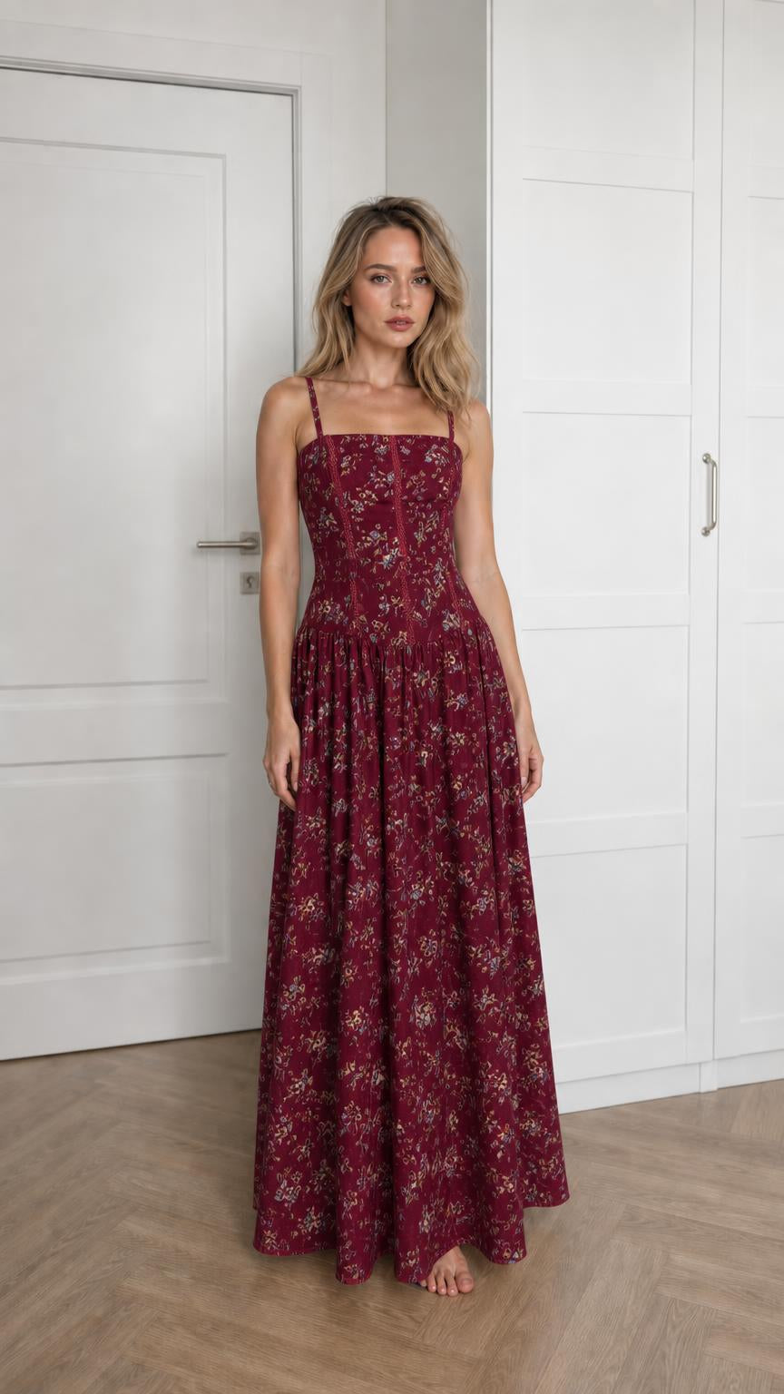 Front view of woman wearing burgundy floral maxi dress