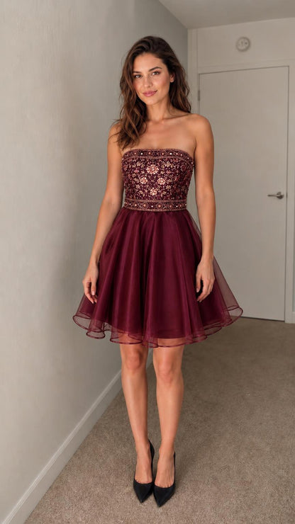 Front view of burgundy strapless embroidered cocktail dress