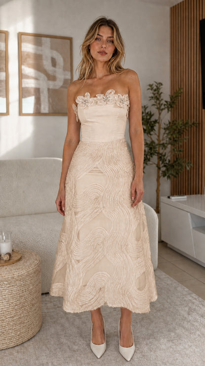 Front view of model wearing champagne strapless midi dress