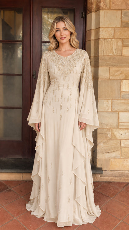 Model wearing champagne beaded long sleeve maxi dress