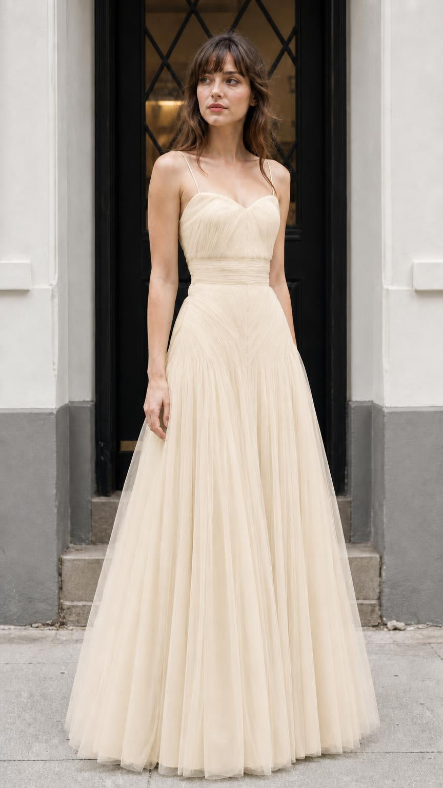 Front view of model wearing champagne neutral tulle dress