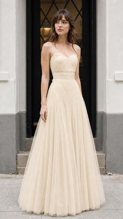 Front view of model wearing champagne neutral tulle dress