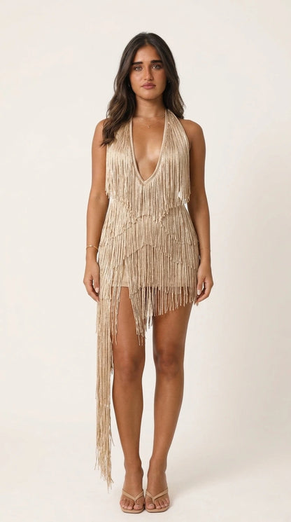Model wearing champagne fringe mini dress against white background